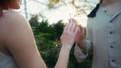 cinematic-medium-shot-in-slowmotion-of-Young-couple-touching-hands-blindfolded-in-nursery