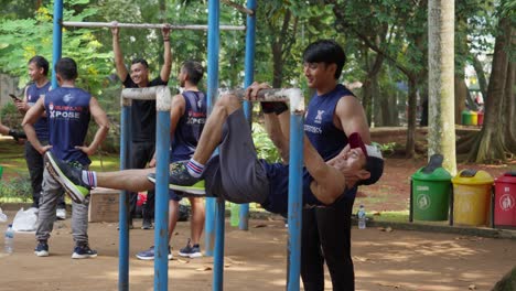 Young-men-practice-calisthenics-at-outdoor-gym-in-Indonesia,-slo-mo