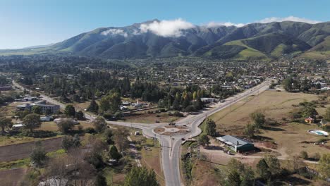 Aerial-view-of-roundabout-and-road-in-the-town-of-Tafí-del-Valle-in-the-tourist-province-of-Tucumán,-northwest-climate-of-Argentina