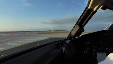 Immersive-pilot-POV-taxiing-a-jet-along-an-airport-taxiway-following-another-jet