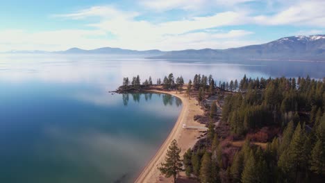 Lake-Tahoe-USA,-Aerial-View-of-Sand-Harbor-Beach-and-Park,-Sky-and-Clouds-Mirror-Reflections-on-Calm-Water