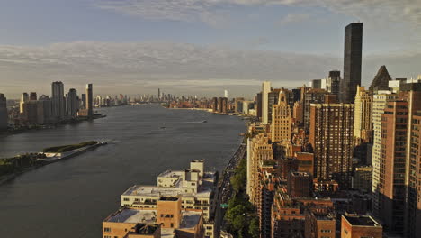 NYC-New-York-Aerial-v387-flyover-Sutton-Place-capturing-traffic-on-FDR-drive,-riverside-Midtown-Manhattan-cityscape-and-UN-building-complex-at-sunrise---Shot-with-Mavic-3-Pro-Cine---September-2023