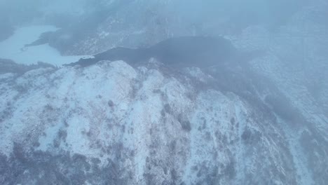 Aerial-View-Of-Snowy-Mountain-Range-And-Frozen-Svartediket-Lake-In-Bergen,-Vestland-County,-Norway