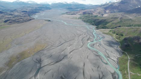 Aerial-view-of-a-blue-glacier-river-system-coming-out-from-Vatnajokull-National-Park-in-Iceland-during-summer,-formed-by-glacier-floods