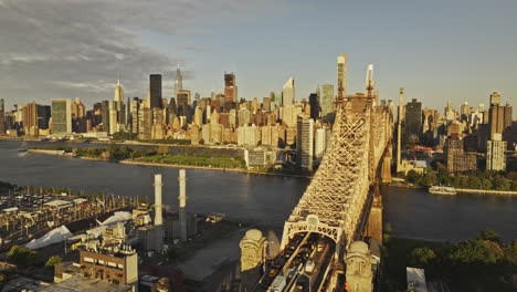 NYC-New-York-Aerial-v383-drone-flyover-Hunters-Point-capturing-traffic-on-Queensboro-Bridge,-Roosevelt-Island,-and-sunrise-cityscape-of-Upper-East-Side---Shot-with-Mavic-3-Pro-Cine---September-2023