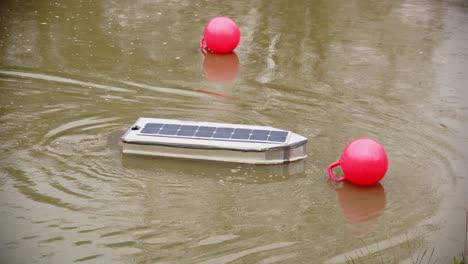 RC-solar-boat-losing-control-and-bumping-into-buoy-multiple-times