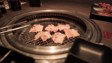 Close-up-footage-of-meat-grilling-on-a-tabletop-grill
