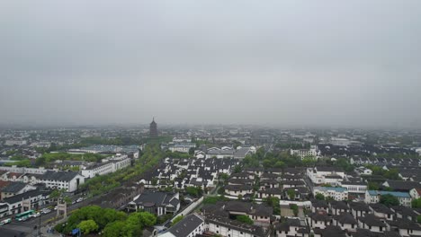 Drone-ascends-over-river-unveiling-entire-Suzhou-city-and-The-North-Pagoda,-China