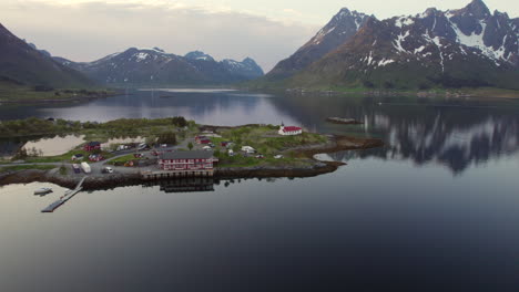 Beautiful-aerial-shot-over-the-Austnesfjorden-fjord,-its-mountains-and-small-towns-at-golden-hour