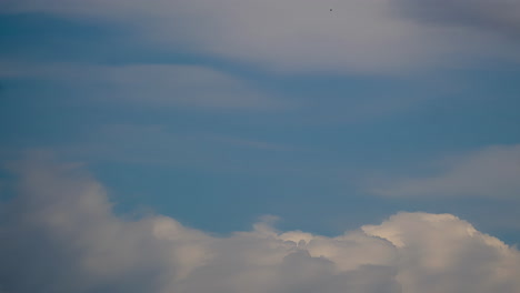 Billowing-columns-of-clouds-rise-up-in-air-dissapearing-against-soft-hazy-sky