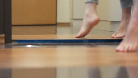 Woman-feet-dancing-barefoot-in-front-of-mirror-in-apartment