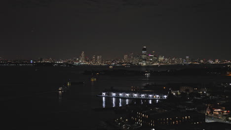 NYC-New-York-Aerial-v285-flyover-Red-Hook-capturing-ferries-on-the-Channel,-views-of-Jersey-City-and-Governors-Island,-night-cityscape-of-Lower-Manhattan---Shot-with-Inspire-3-8k---September-2023