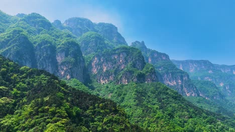 Aerial-view-of-the-mountainous-range-covered-with-lush-forests-in-Huixian,-Henan-Province,-China