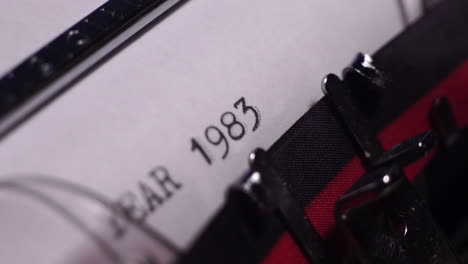 Year-1983,-Typing-on-Blank-White-Paper-in-Vintage-Typewriter,-Close-Up