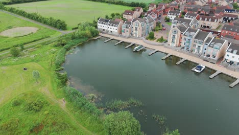 Top-view-of-a-lake-with-yachts-halted-and-luxury-apartments-at-Eastbourne,-England-during-daytime