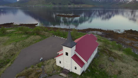 Fantastic-aerial-shot-in-orbit-over-the-Sildpollnes-church-located-in-the-Austnesfjorden-fjord-on-the-Lofoten-Islands,-Norway