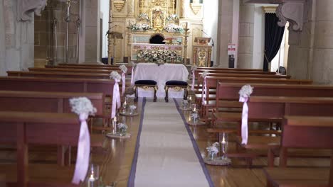 Interior-of-a-beautifully-decorated-church-aisle-with-floral-arrangements-and-ornate-altar