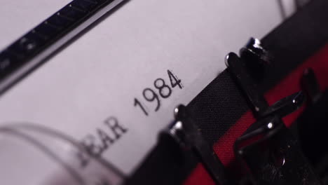Year-1984,-Typing-on-Blank-White-Paper-in-Vintage-Typewriter,-Close-Up