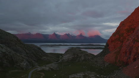 Seven-Sisters-mountain-range-in-red-sunset-light,-Drone-flying-towards-the-epic-mountain-range