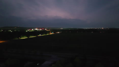 Traffic-On-Road-At-Night-With-Lightning-Strikes-In-Springdale,-Arkansas