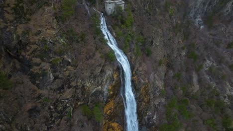 Waterfall-flowing-down-a-rugged-cliffside-creates-a-stunning-contrast-against-the-natural-landscape