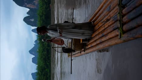 Hanfu-girl-in-traditional-clothing-holds-a-Pipa-instrument-on-a-bamboo-raft-floating-on-Li-River,-China