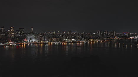 NYC-New-York-Aerial-v274-drone-flyover-Mill-Rock-capturing-vehicle-traffic-on-FDR-drive-along-Harlem-river-and-night-cityscape-of-Upper-Manhattan---Shot-with-Inspire-3-8k---September-2023