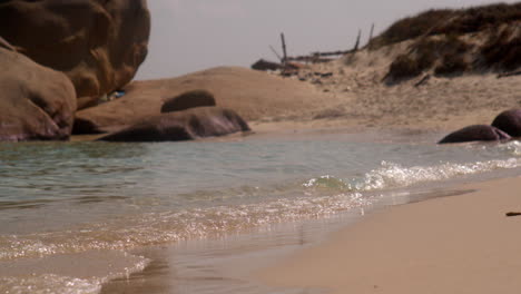 Small-ocean-sea-waves-crashing-on-to-sandy-tropical-beach