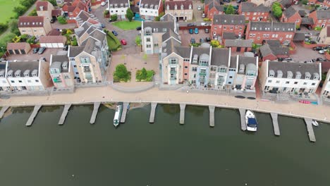Top-angle-view-of-luxury-yachts-halted-and-parked-on-lake-beside-apartments-in-East-Sussex,-England