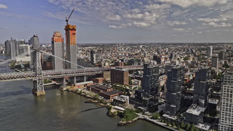 NYC-New-York-Aerial-v422-drone-flyover-East-river-capturing-bridge-crossing,-waterfront-residential-apartments,-Williamsburg-Brooklyn-cityscape-at-daytime---Shot-with-Mavic-3-Pro-Cine---September-2023