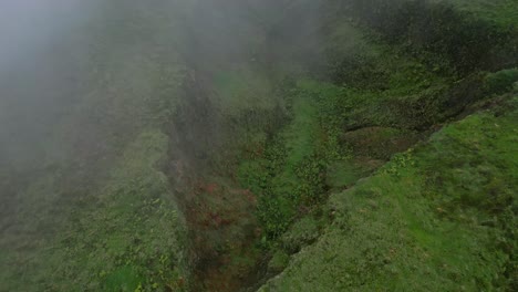 Misty-aerial-view-of-the-lush-green-crater-of-Lagoa-do-Fogo-on-a-foggy-day