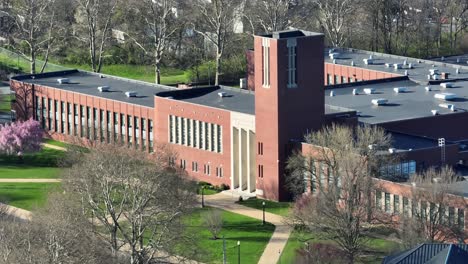 Public-school-with-red-bricks-and-tower-during-sunny-day-in-spring