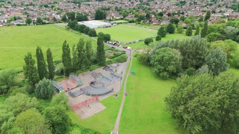 Aerial-pan-shot-of-children-skating-on-skating-area-in-Priory-Park-in-Huntingdonshire,-England