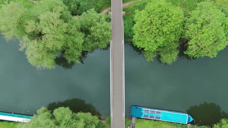 Top-view-of-a-bridge-over-a-waterway-joining-two-lands-in-Huntingdonshire,-UK