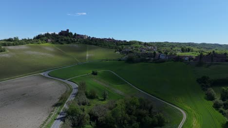 aerial-arrival-at-Gabiano,-Italy,-picturesque-village-where-medieval-castle-tours-and-rare-wines-attract-visitors