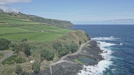 Coastal-road-and-volcanic-rocky-cliffs-of-Santo-Antonio,-Sao-Miguel-of-Azores-islands