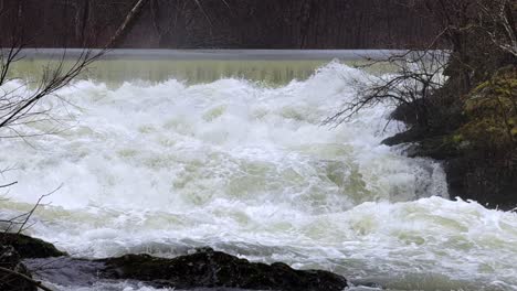 Slow-motion,-strong-rapids-on-a-little-waterfall-after-recent-snow-melt-in-Beacon-NY