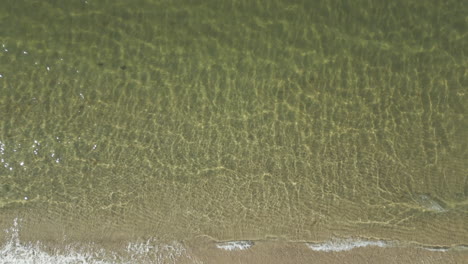 Above-View-Of-Beach-With-Calm-Waters-During-Sunrise