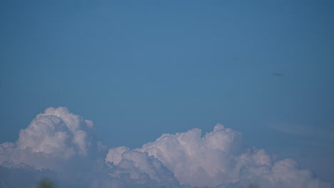 Clouds-recede-swirling-into-nothing-against-a-pastel-blue-sky-with-open-space-for-text