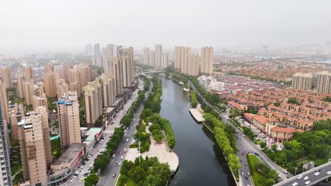 Aerial-view-of-Linyi-city-skyline-with-air-pollution,-China