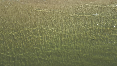 Calm-And-Transparent-Water-Of-Pristine-Beach-During-Sunrise