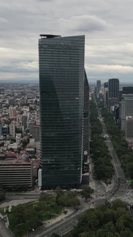 Drone-captures-of-towering-buildings-on-Paseo-de-la-Reforma-in-Mexico-City,-vertical-mode