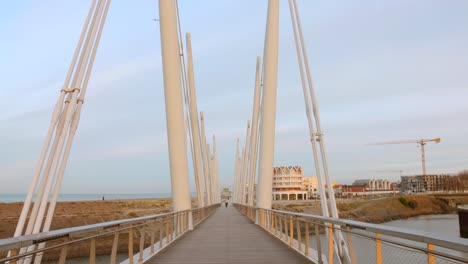 Modern-bridge-structure-with-a-coastal-city-background-in-Dunkerque,-France