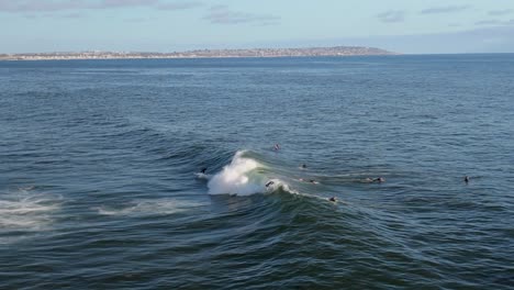 Above-View-Of-Surfers-Riding-Tidal-Waves-Near-Bird-Rock-In-San-Diego,-California-USA