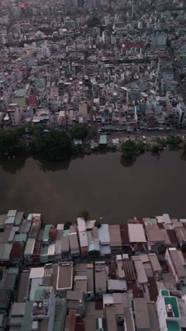 Urban-density-along-canal-in-poor-area-of-Ho-Chi-Minh-City,-Vietnam-showing-rooftops-in-late-afternoon-light