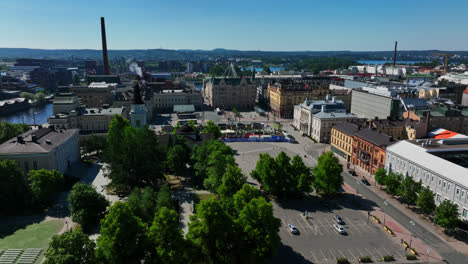 Aerial-tracking-shot-of-the-Keskustori-market-and-the-cityscape-of-sunny-Tampere