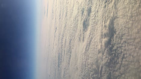 calm-shot-from-an-airplane-window-of-the-sky-above-a-dense-carpet-of-white-clouds