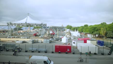 View-of-preparation-work-for-the-Olympic-games-in-Paris,-Place-de-la-Concorde-with-locals-cycling-on-street-at-foreground