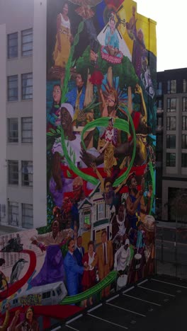 Vertical-Aerial-View-of-Ascendance-Mural-on-Greenlining-Institute-Building-in-Downtown-Oakland,-California-USA