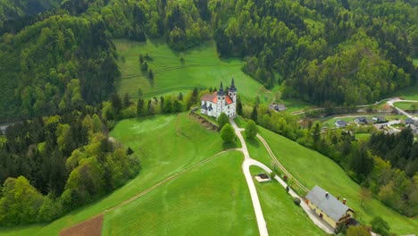 Aerial-view-of-historic-cerkev-volbenka-church-on-green-mountain-in-Slovenia